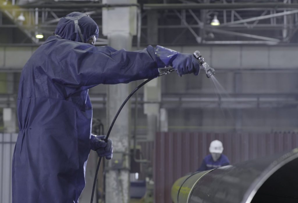 male-holding-spray-gun-and-painted-steel-man-pain-2023-11-27-04-52-01-utc-min